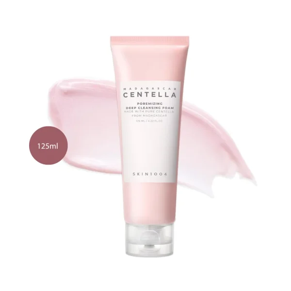 SKIN1004 Centella Poremizing Deep Cleansing Foam 125ml tube over a light pink cream swatch.