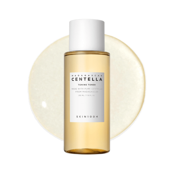 SKIN1004 Madagascar Centella Toning Toner bottle over a glossy, light gold liquid swatch.