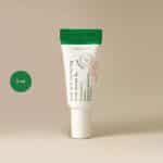AXIS-Y Dark Spot Correcting Glow Serum 5ml mini tube with green cap and white body.