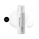 REJURAN Moisture Bubble Cleansing Water 150ml white pump bottle over foam backdrop.
